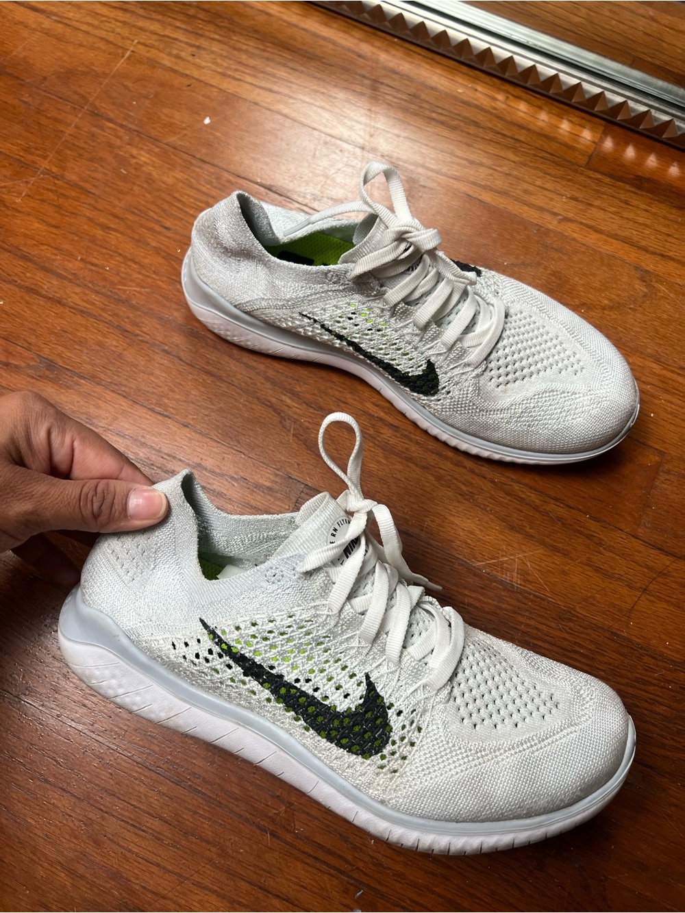 Nike Women’s White Flyknit Sneakers with Black Swoosh and Lime Accents
